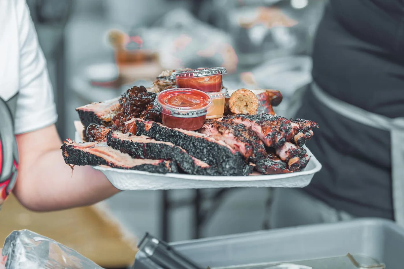 A tray of sliced barbecue with sauce, from Connected Austin’s food imagery